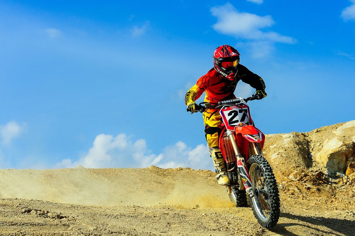 Motocross rider braking into a corner on a Honda dirt bike