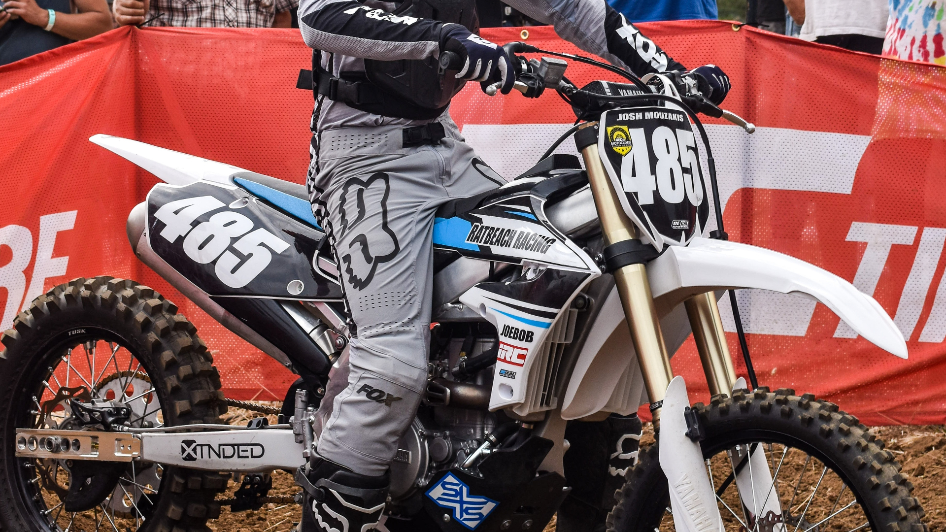 Hill-climb racer in the staging area wearing Fox Racing motocross pants