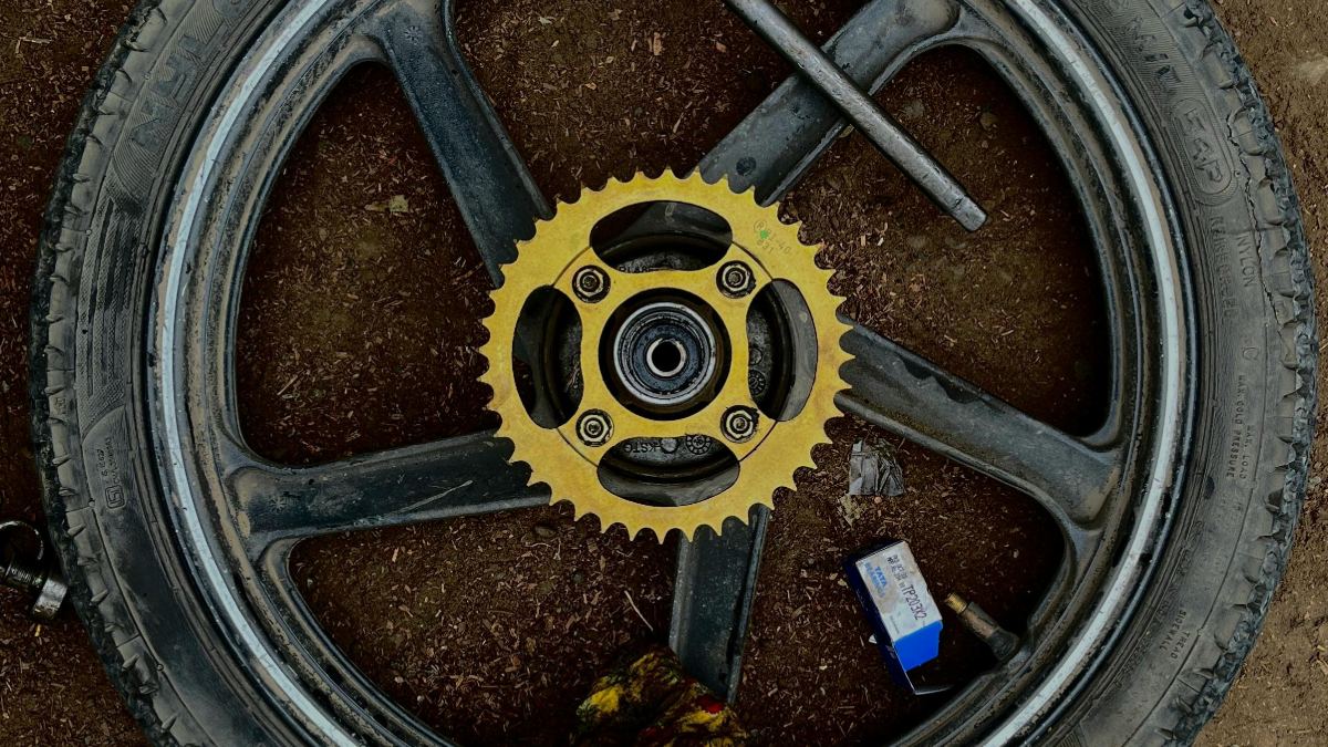 Dirt Bike Wheel And Sprocket Laying On Ground